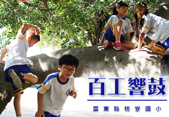 屏東縣坊寮國小百工體驗活動，學生們在樹蔭下體驗各種職業，有學生做出心形手勢、爬行、坐在石頭上參與活動。