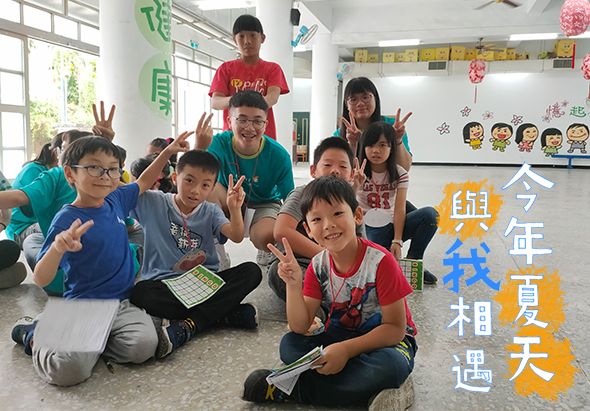 教室內一群學生圍坐成圈，做出勝利手勢，開心地笑著。牆上貼有中文字卡和學生作品。右下角有「令年夏天我們來過」的文字和橙色裝飾，記錄這次暑期活動的美好時光。