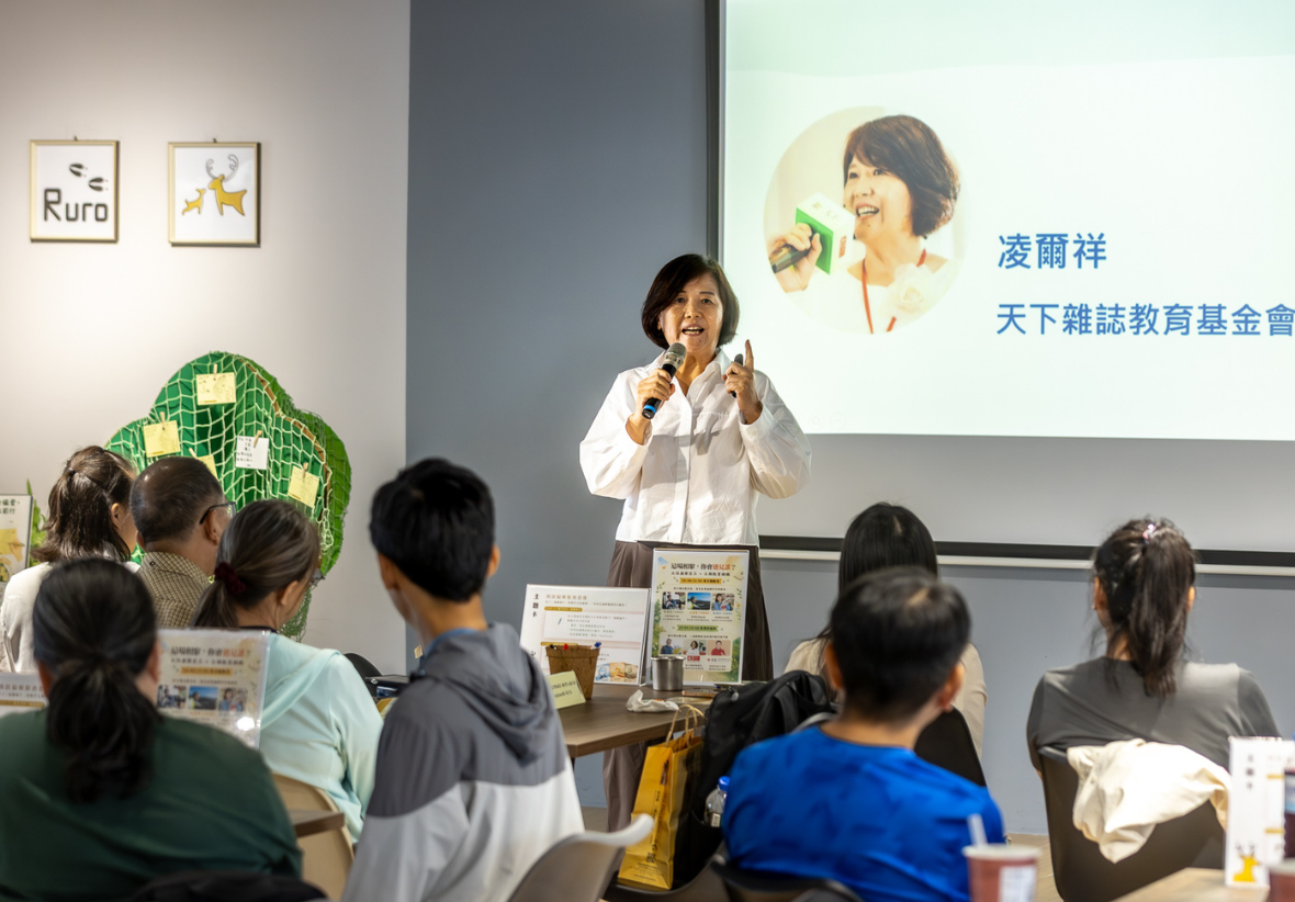 講者凌爾祥於臺前演講，背後螢幕顯示其姓名與「天下雜誌教育基金會」字樣。下方多位聽眾專注聆聽，現場氣氛認真且具互動感。