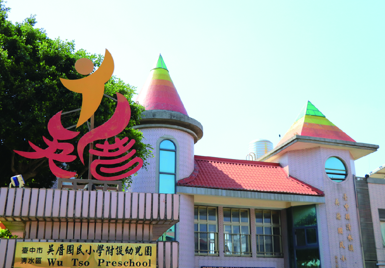 烏日風民小學附設幼兒園外觀，建築物為紫色牆面搭配紅色瓦片屋頂，頂部有彩色尖塔裝飾。左側豎立紅色及黃色藝術雕塑，門牌標示為清水區吳梭風民小學附設幼兒園。